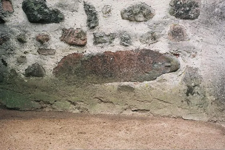 A Prussian idol built into the wall of the church in Prątnica